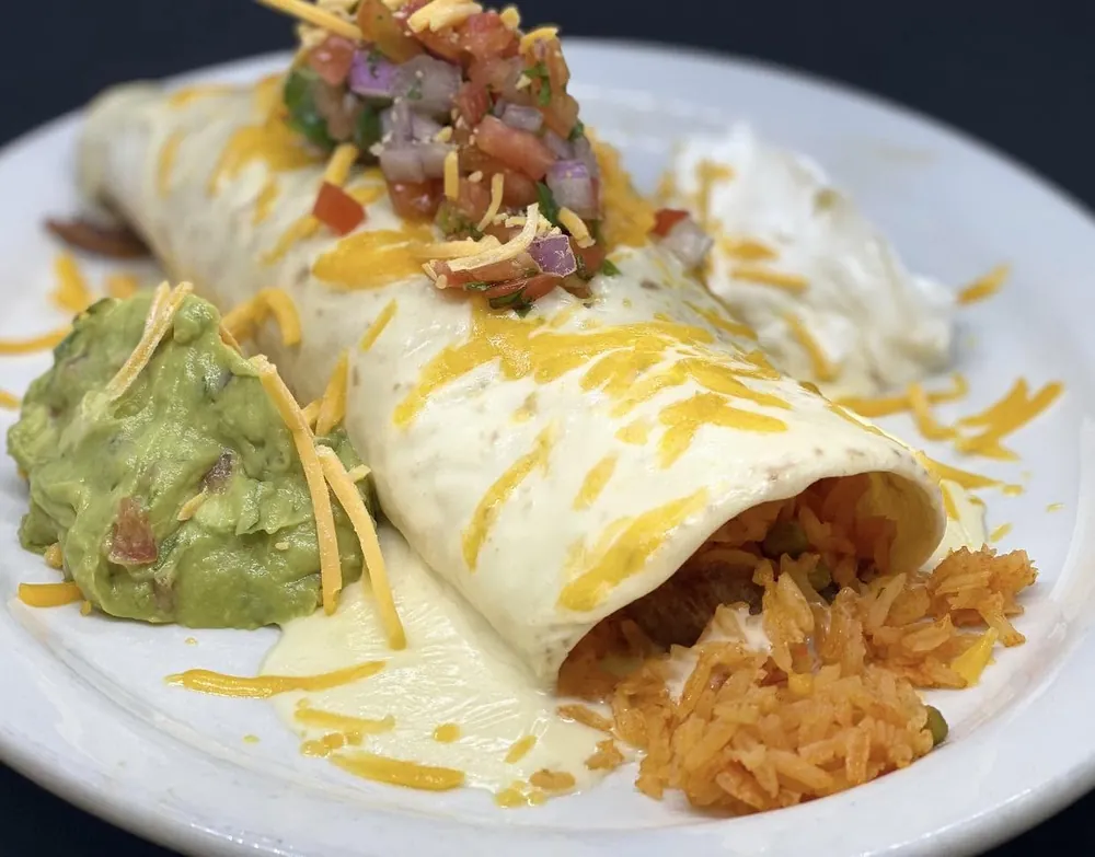 Abuelo Burrito with cheese sauce, pico de gallo, guacamole, sour cream and rice