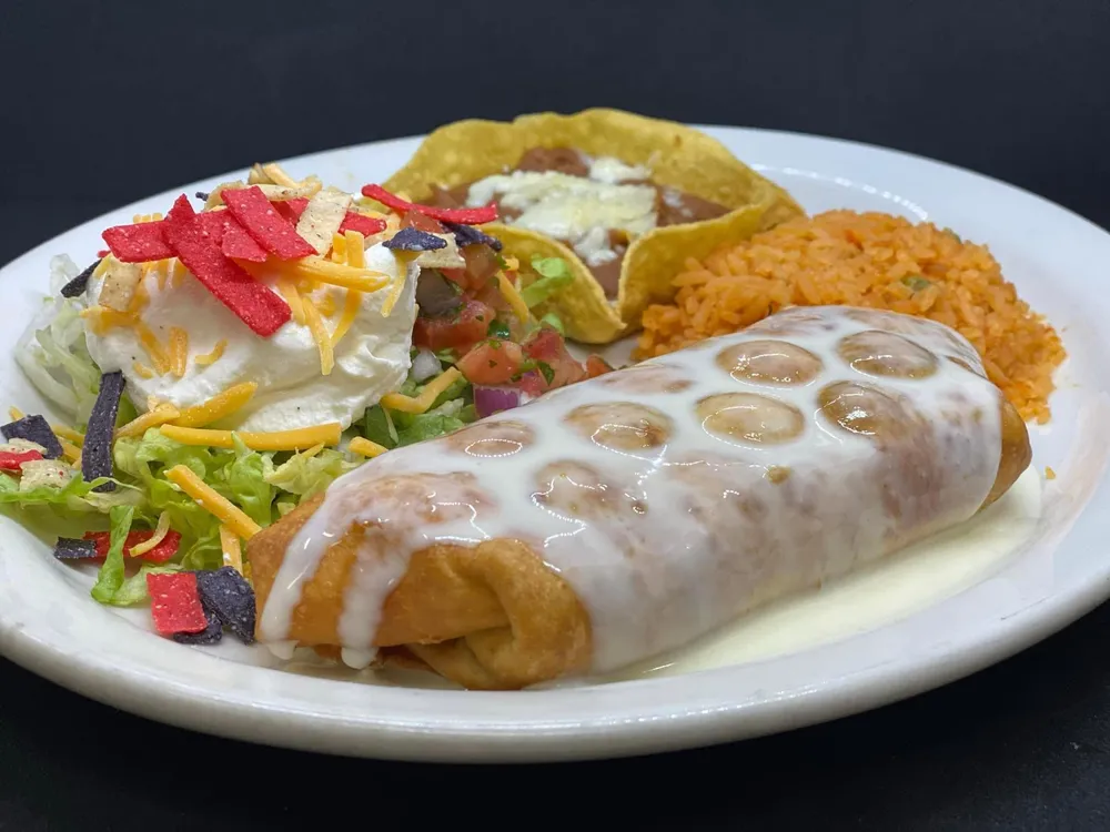 Chimichanga with cheese sauce, salad, rice and beans