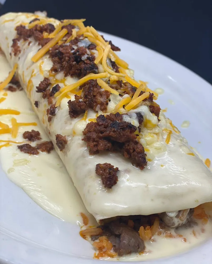 Gringo Burrito topped with cheese sauce, chorizo and shredded cheese