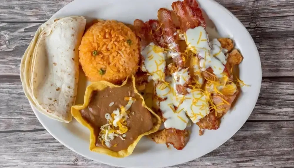 Pollo Feliz: grilled chicken with bacon and cheese sauce, rice, beans and tortillas