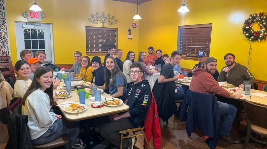 A big group of college students eating together at Lola's